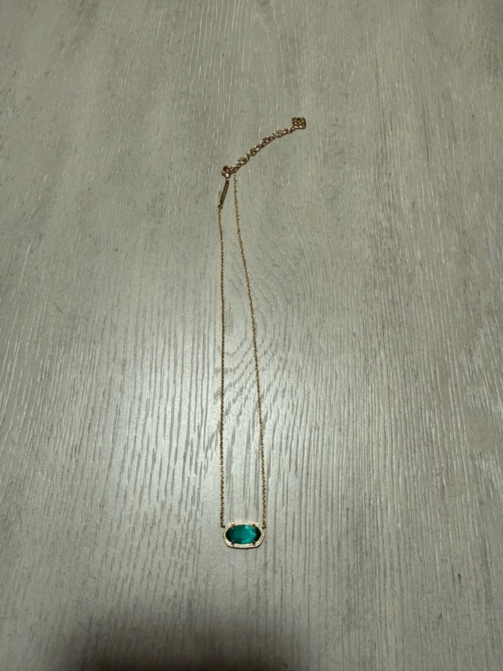 Kendra Scott gold and emerald pendant